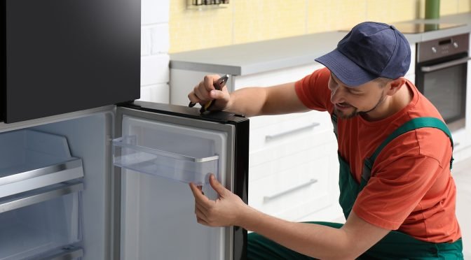 Fast Refrigerator Repair Technician working on unit components